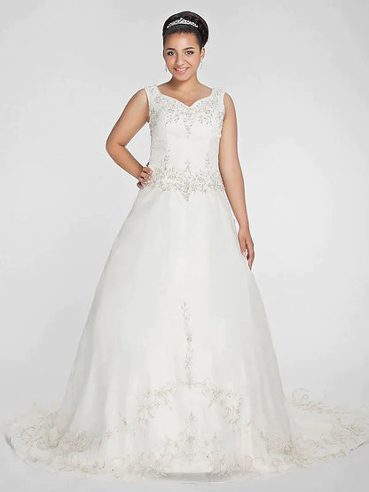 Front view of an elegant ivory plus size ball gown wedding dress with V-neck and beaded lace bodice.