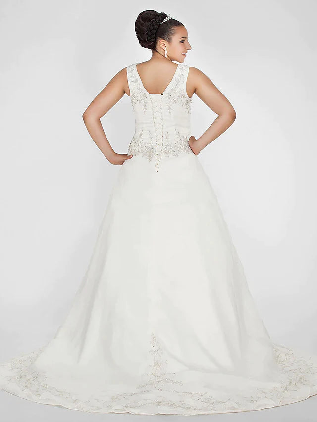 Side view of the ivory ball gown wedding dress, showcasing the court train and flowing organza skirt.