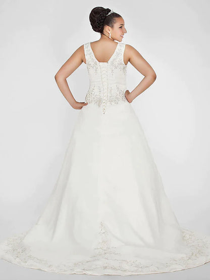 Side view of the ivory ball gown wedding dress, showcasing the court train and flowing organza skirt.