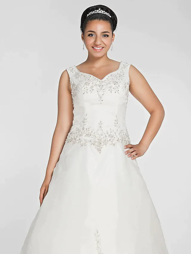 Back view of the plus size wedding dress, highlighting the intricate lace details and court train.