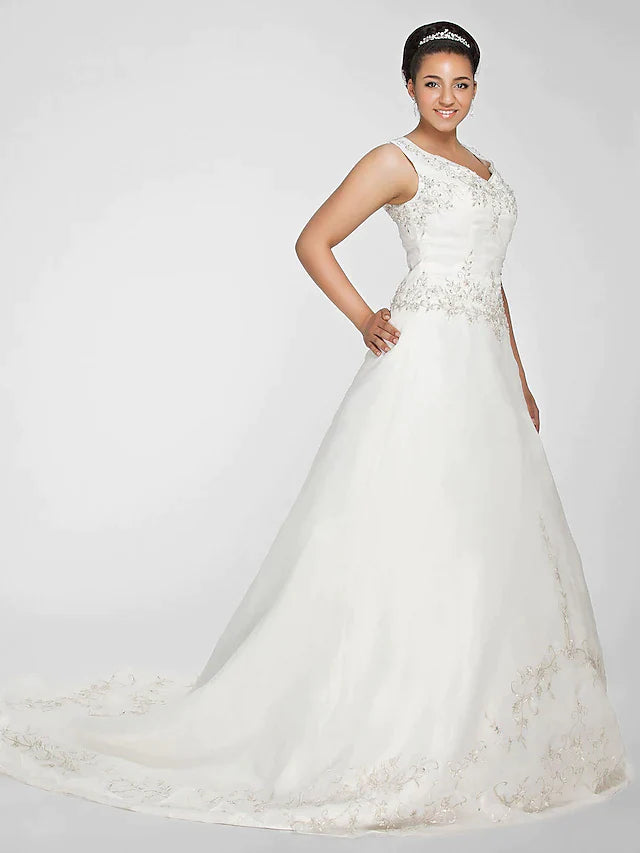 Model wearing the elegant ivory ball gown wedding dress, posing gracefully.