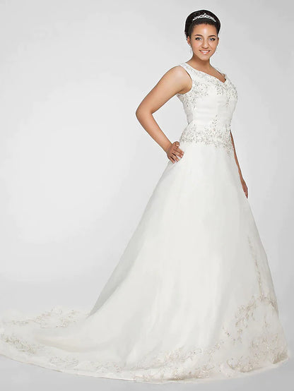 Model wearing the elegant ivory ball gown wedding dress, posing gracefully.