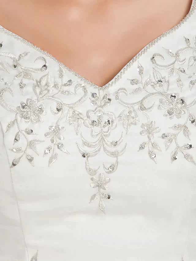 Full length view of the plus size bridal gown, showing its voluminous skirt and straps.