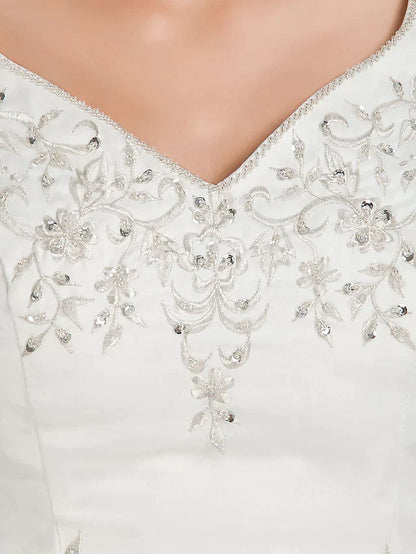 Full length view of the plus size bridal gown, showing its voluminous skirt and straps.