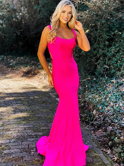 Woman in elegant jersey ruched strap floor-length prom dress, front view.
