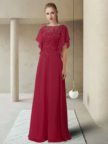 Woman wearing an elegant jewel neck, half-sleeve, floor-length Mother of the Bride dress with lace appliques.
