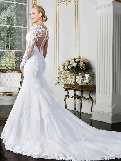Back view of a white lace wedding gown, highlighting the long sleeves and flowing court train.