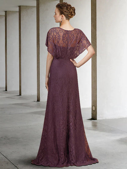 Woman modeling a pleated lace short sleeve formal gown.