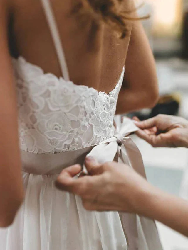 Full length view of the bride in the elegant spaghetti strap wedding dress.