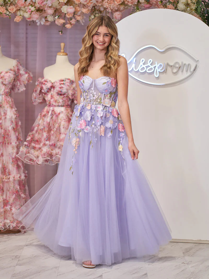 Model wearing a lavender A-line strapless tulle dress with 3D flowers.