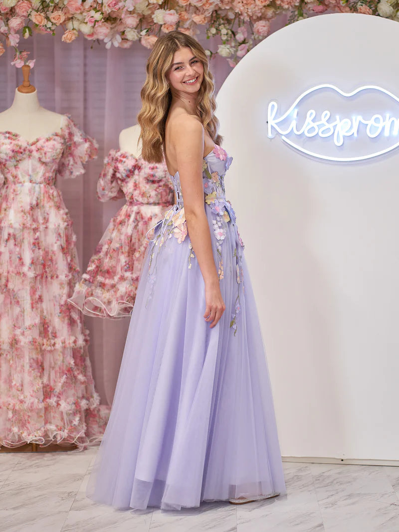 Model twirling in a lavender A-line strapless tulle dress.