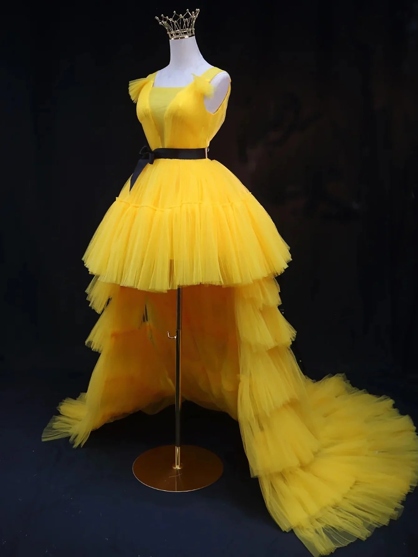 Back view of a light blue A-line high-low tulle dress with flowing hem.