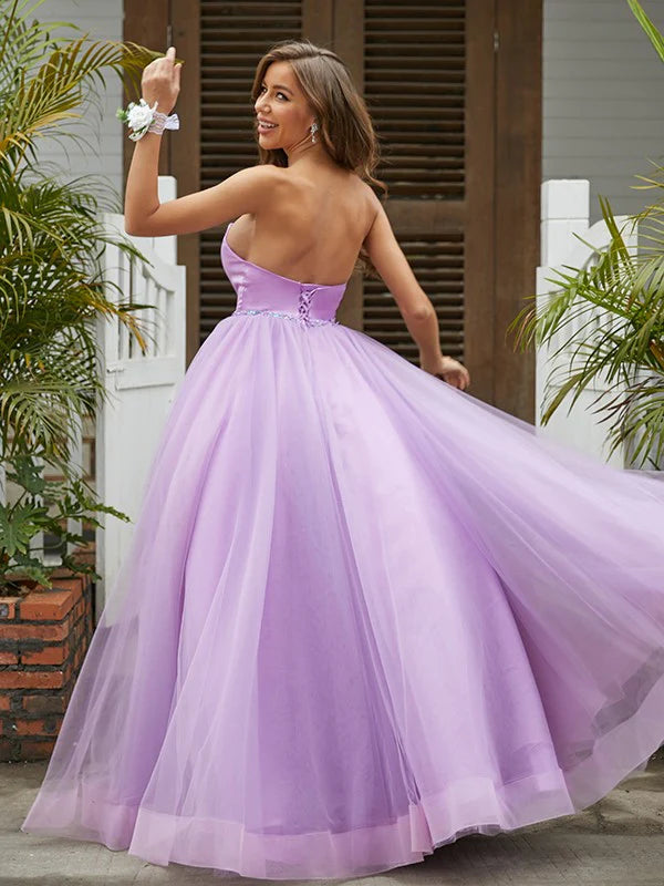 Side view of an elegant light blue A-line prom dress, showcasing floor-length design.