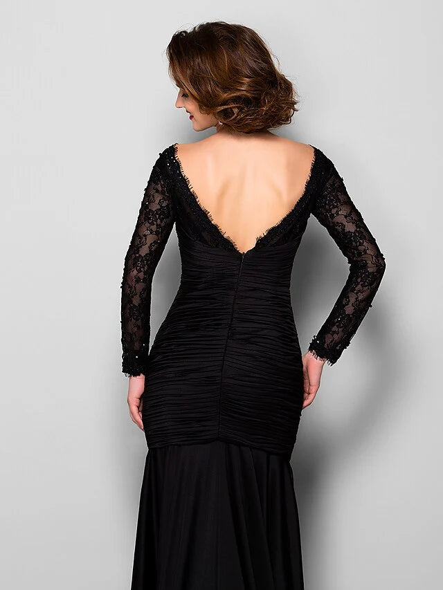 Close-up of the jewel neck and lace detailing on the elegant formal dress.