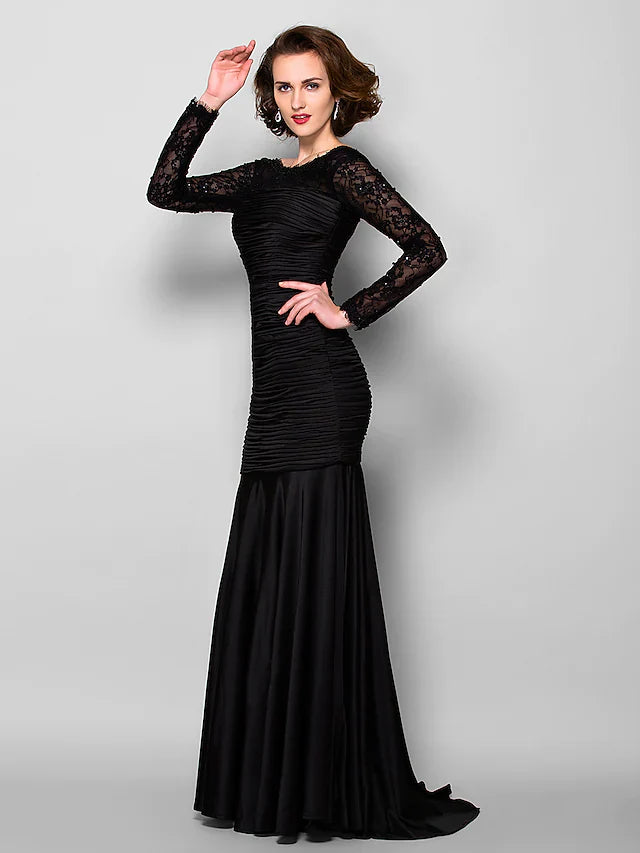 Detailed view of the long sleeves and ruched beading on the formal gown.