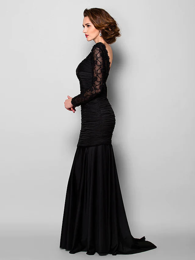 Woman posing in the elegant Mother of the Bride dress, showing the full silhouette.