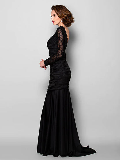 Woman posing in the elegant Mother of the Bride dress, showing the full silhouette.