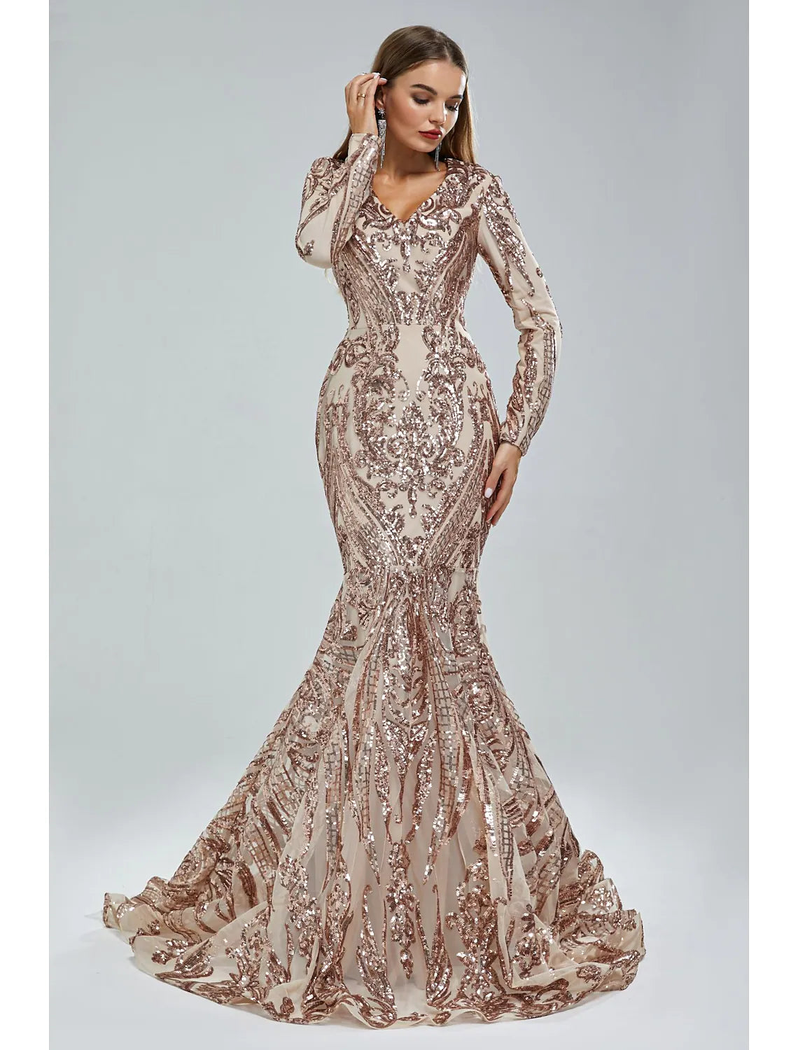 Woman posing in the mermaid trumpet formal dress, showcasing its elegant silhouette.