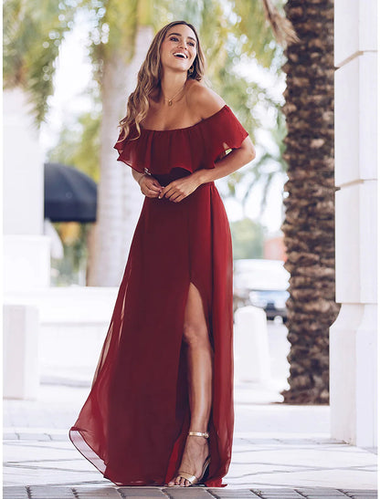 Woman wearing a purple ruched long maxi party dress with U-neck and short sleeves.