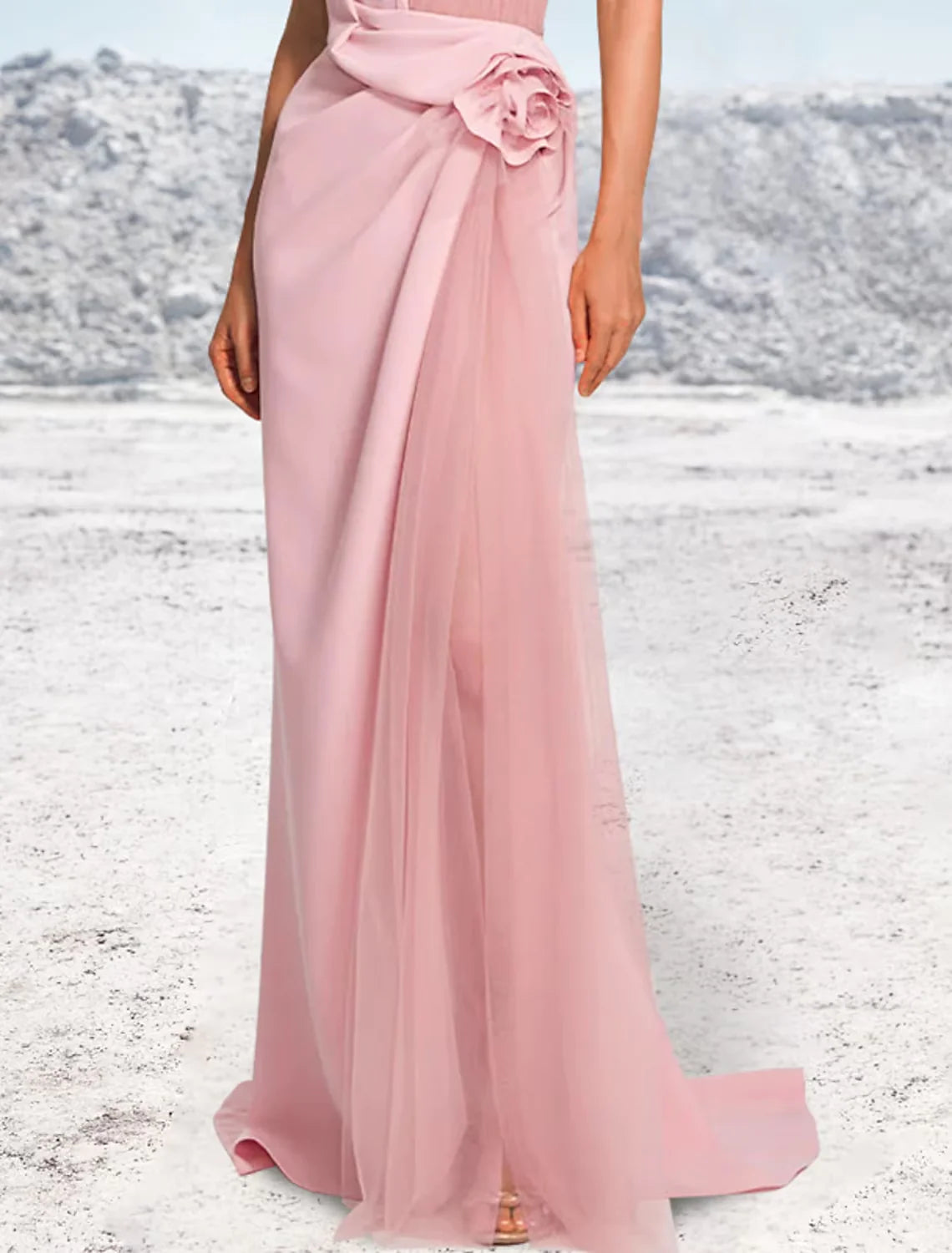 Back view of a woman in a sophisticated mermaid halter evening gown, showcasing the sweep train.