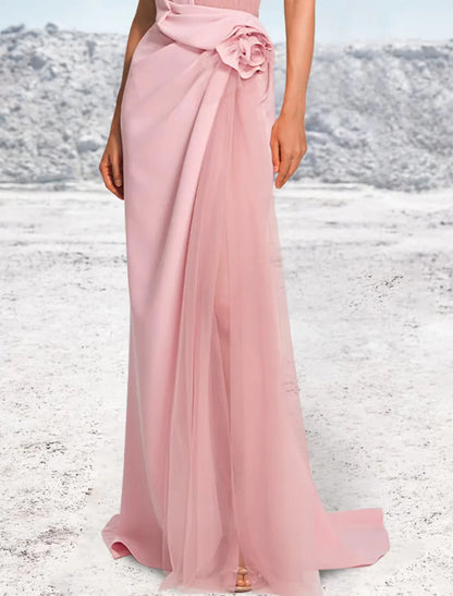 Back view of a woman in a sophisticated mermaid halter evening gown, showcasing the sweep train.