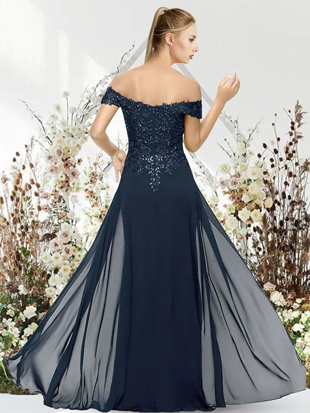 Close-up of the off-shoulder neckline and beaded applique detail on the back of the mermaid gown.