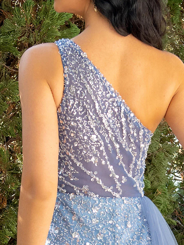 Close-up of the intricate sequin and tulle fabric on the mermaid trumpet dress.