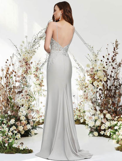 Full view of the elegant navy blue mermaid trumpet gown with sweep train.