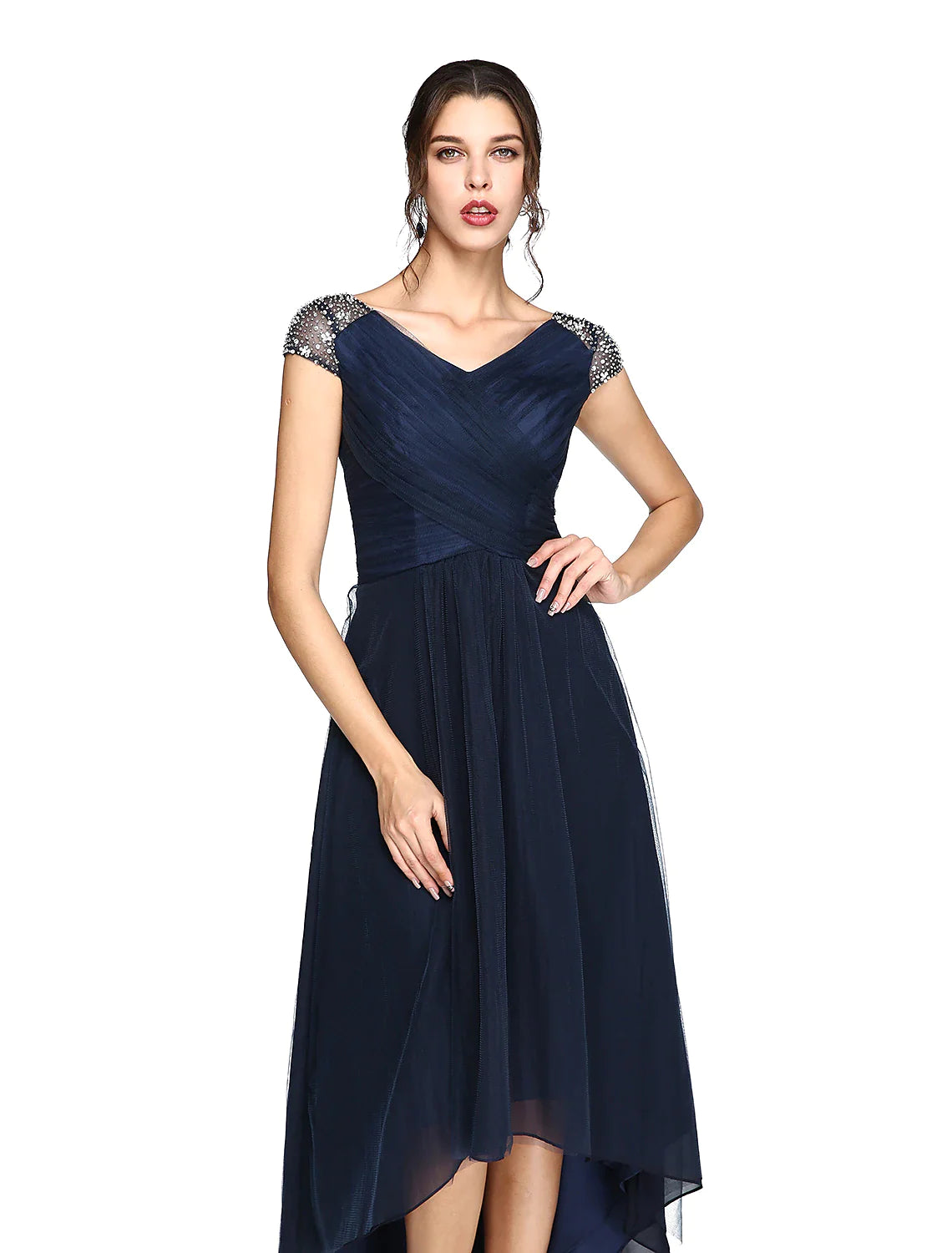 Back view of a model in the light-colored sheath column dress, featuring a V-back and criss-cross pleats.