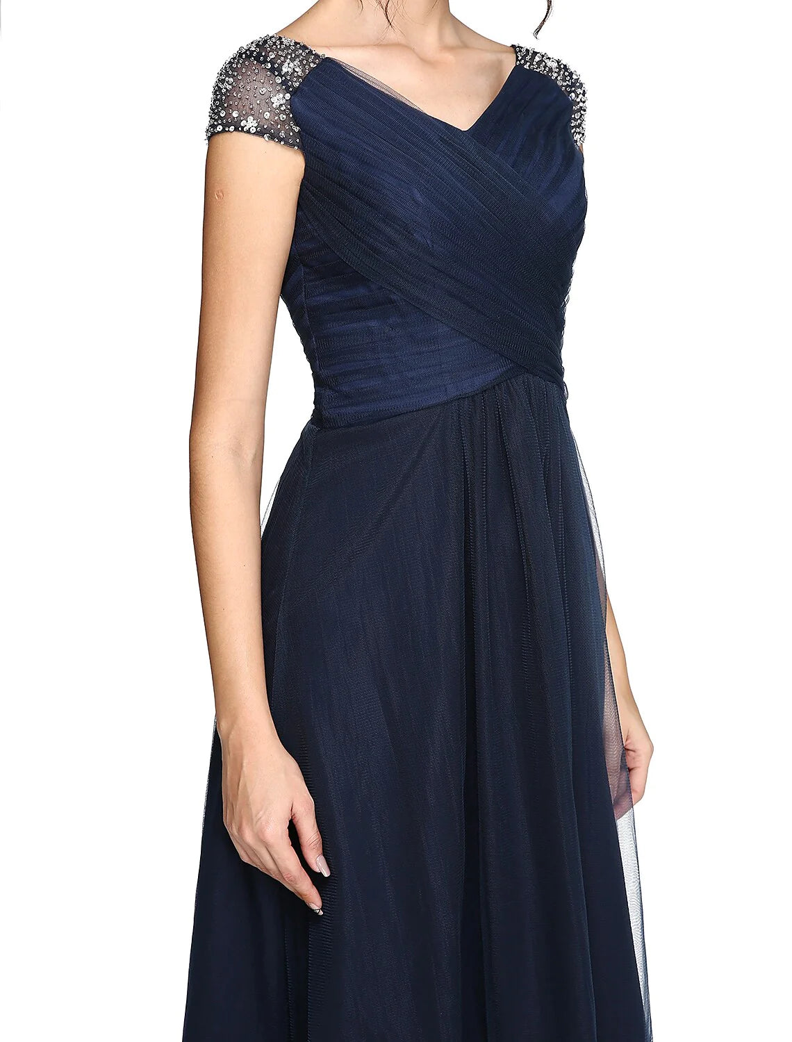 Full-length view of a model in the light-colored sheath column dress, suitable for wedding guests.