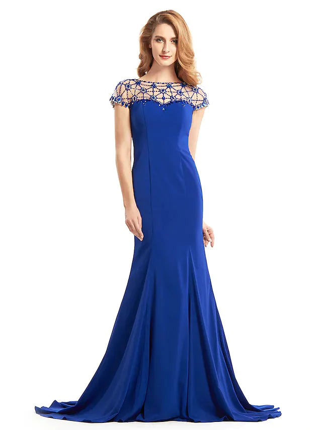 Close-up of the beaded bateau neckline and short sleeve on the navy dress.