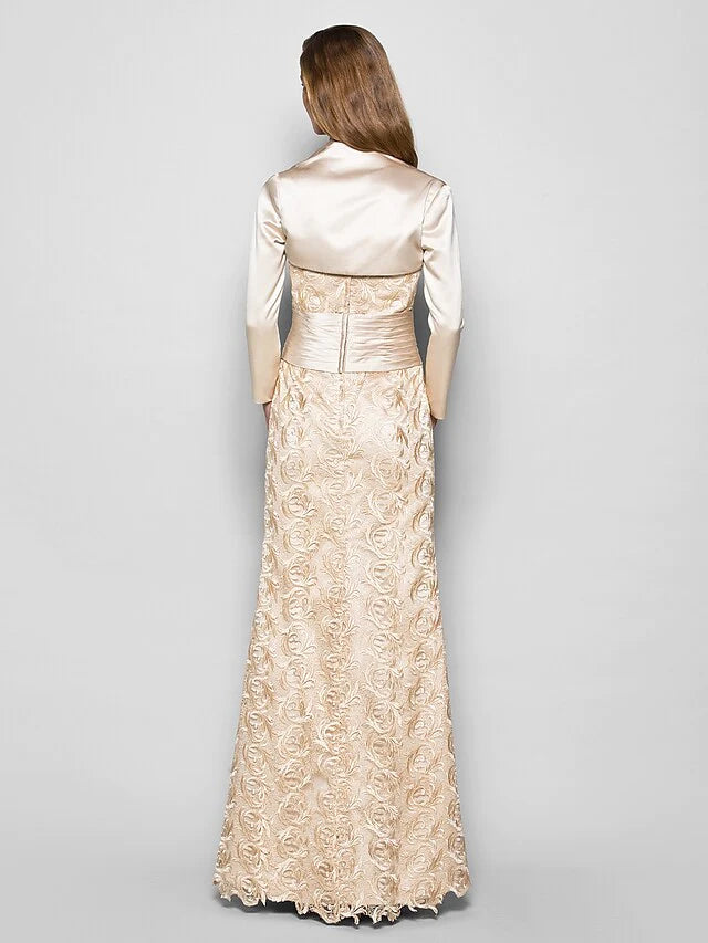 Side view of the navy blue mother of the bride dress, showcasing the flowing floor-length skirt and sleeve detail.