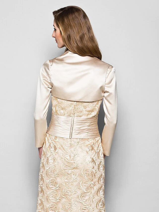 Detail of the 3/4 length sleeve and ruched waistline on the navy blue formal gown.