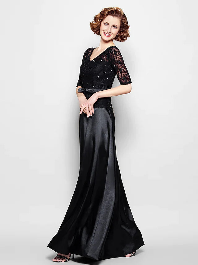 Woman wearing an elegant navy blue V-neck Mother of the Bride gown with lace and half sleeves.