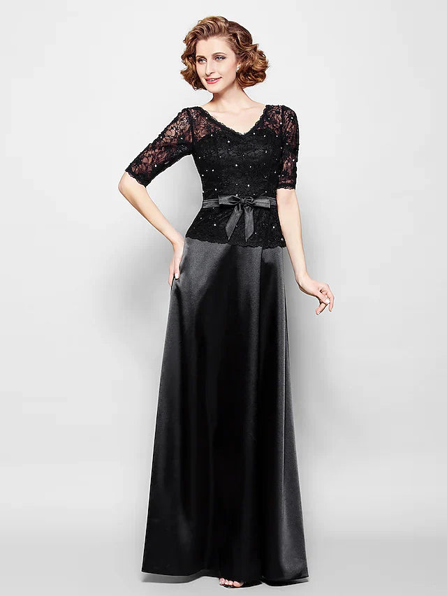 Back view of the navy blue Mother of the Bride dress, featuring a delicate ribbon bow sash.