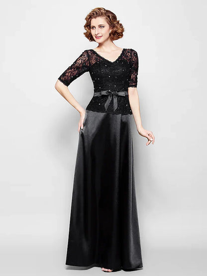 Back view of the navy blue Mother of the Bride dress, featuring a delicate ribbon bow sash.