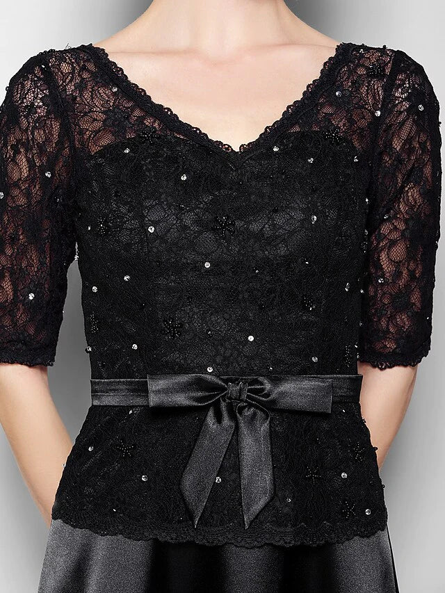 Full view of the navy blue formal gown, highlighting its elegant drape and floor-length design.