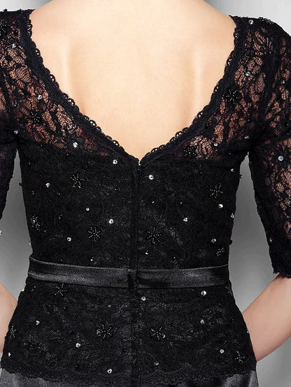 Woman in a sophisticated navy blue V-neck dress, suitable for a wedding or special event.