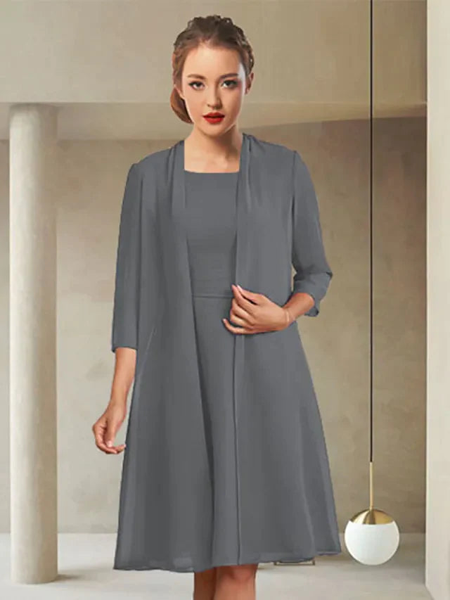 Elegant navy blue chiffon Mother of the Bride dress with jewel neck, long sleeves, and ruching.