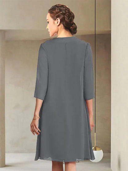 Navy blue knee-length chiffon dress with ruched detail and long sleeves, perfect for formal events.