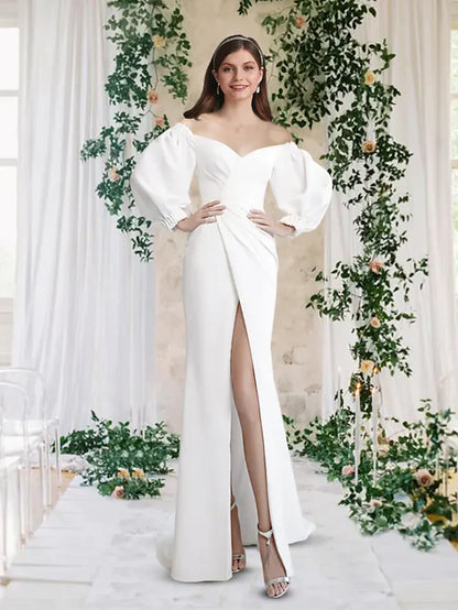 Elegant off-shoulder wedding dress with half sleeves and a split front, worn by a model.