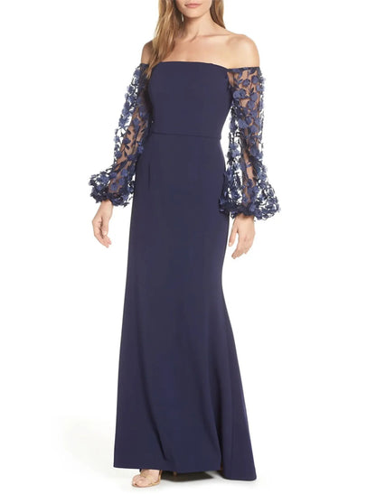 Model wearing an elegant off-shoulder long sleeve mermaid trumpet evening gown with appliques.