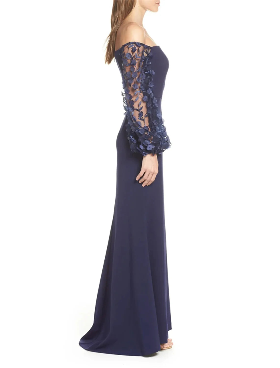 Close-up of the off-shoulder neckline and applique details on the long sleeve dress.