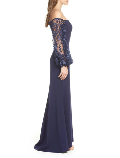 Close-up of the off-shoulder neckline and applique details on the long sleeve dress.