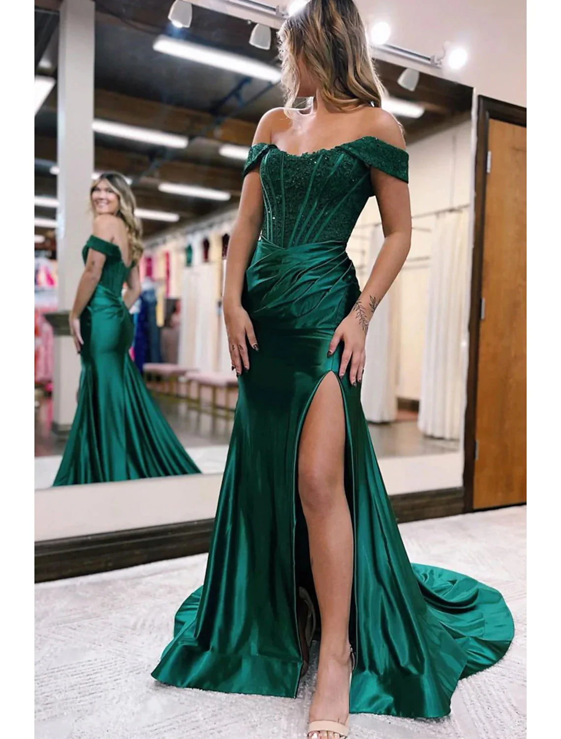 Elegant off-shoulder mermaid trumpet evening gown with a high slit and delicate appliques.