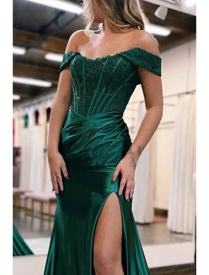 Back view of the off-shoulder mermaid trumpet gown, showcasing the court train and fitted silhouette.