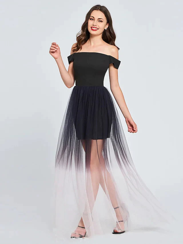 Woman wearing an elegant off-shoulder pleated tulle mini cocktail dress in a light color.