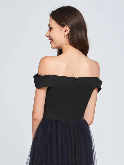 Model showcasing the off-shoulder pleated mini dress from a side view.