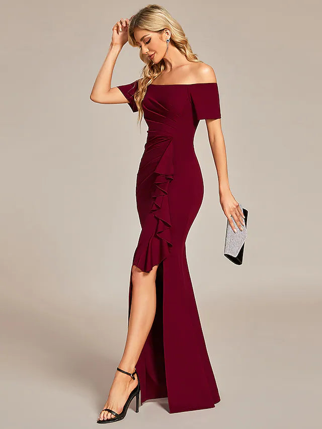 Front view of woman wearing a black off-shoulder ruched long dress.
