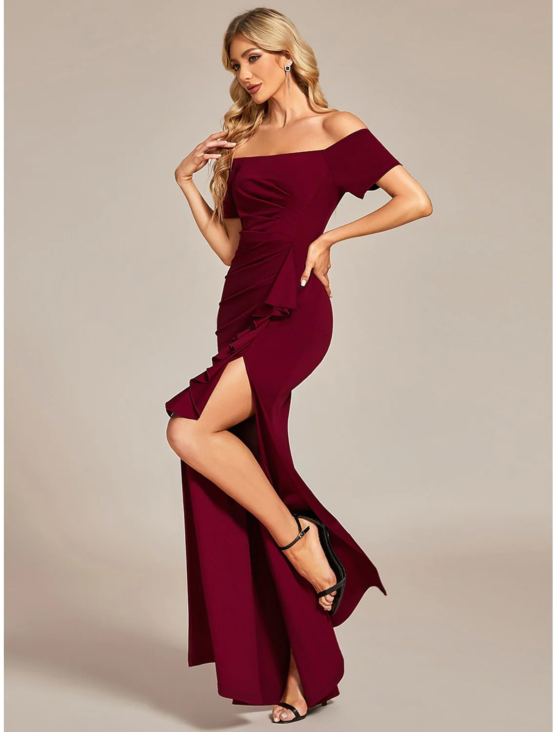 Back view of woman in a black off-shoulder ruched formal dress.